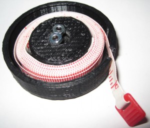 Spring loaded retractable measuring tape