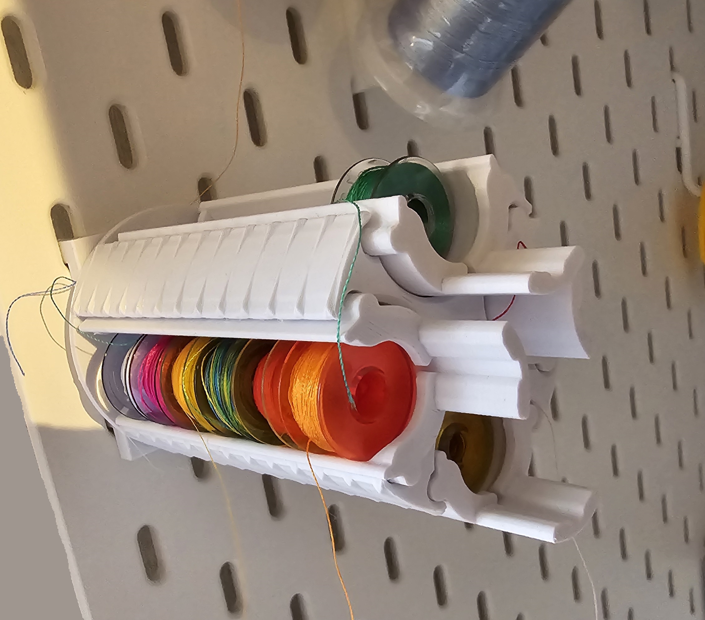 Skadis sewing thread drum holder.