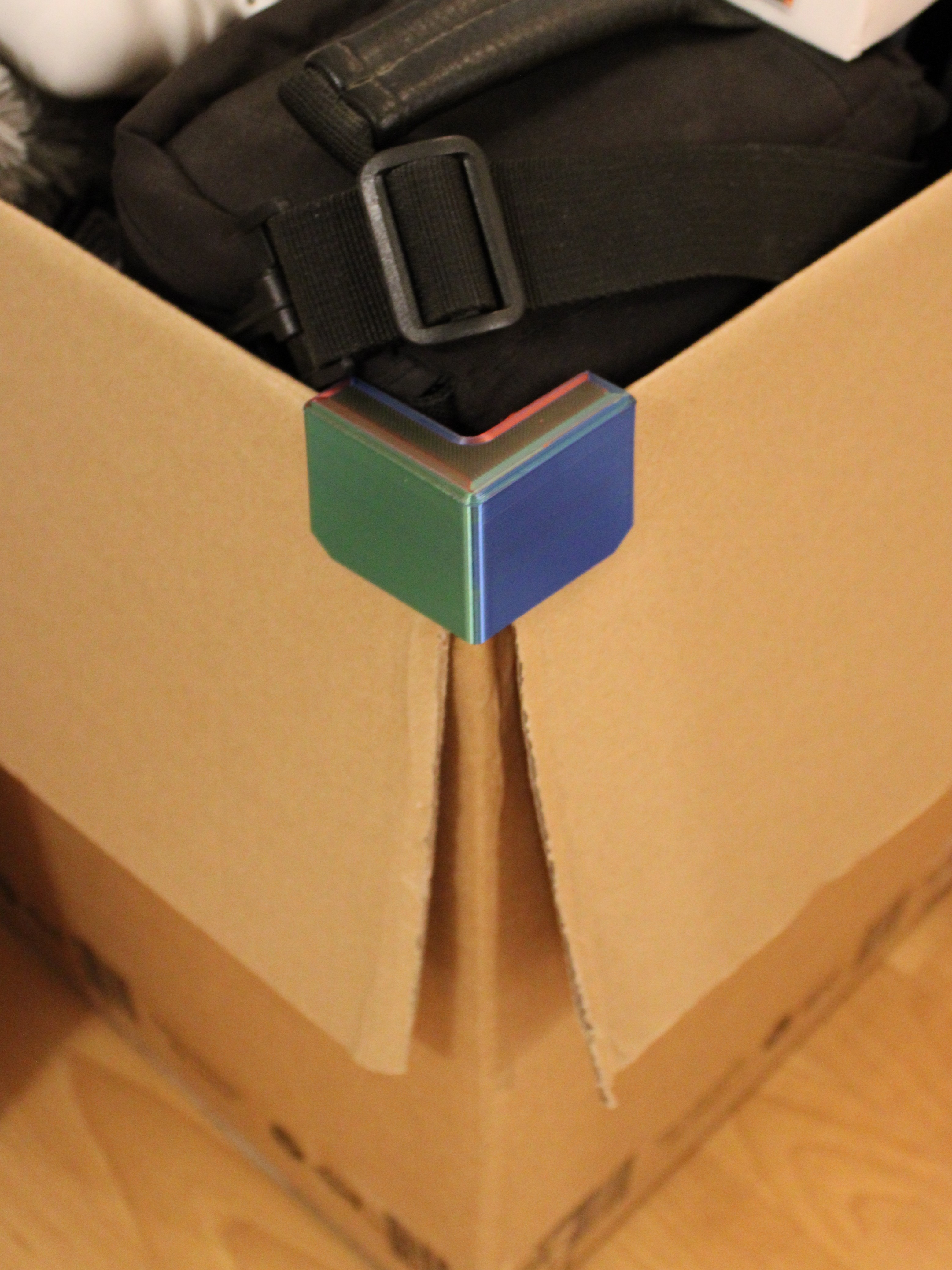 Cardboard box flap holder corner