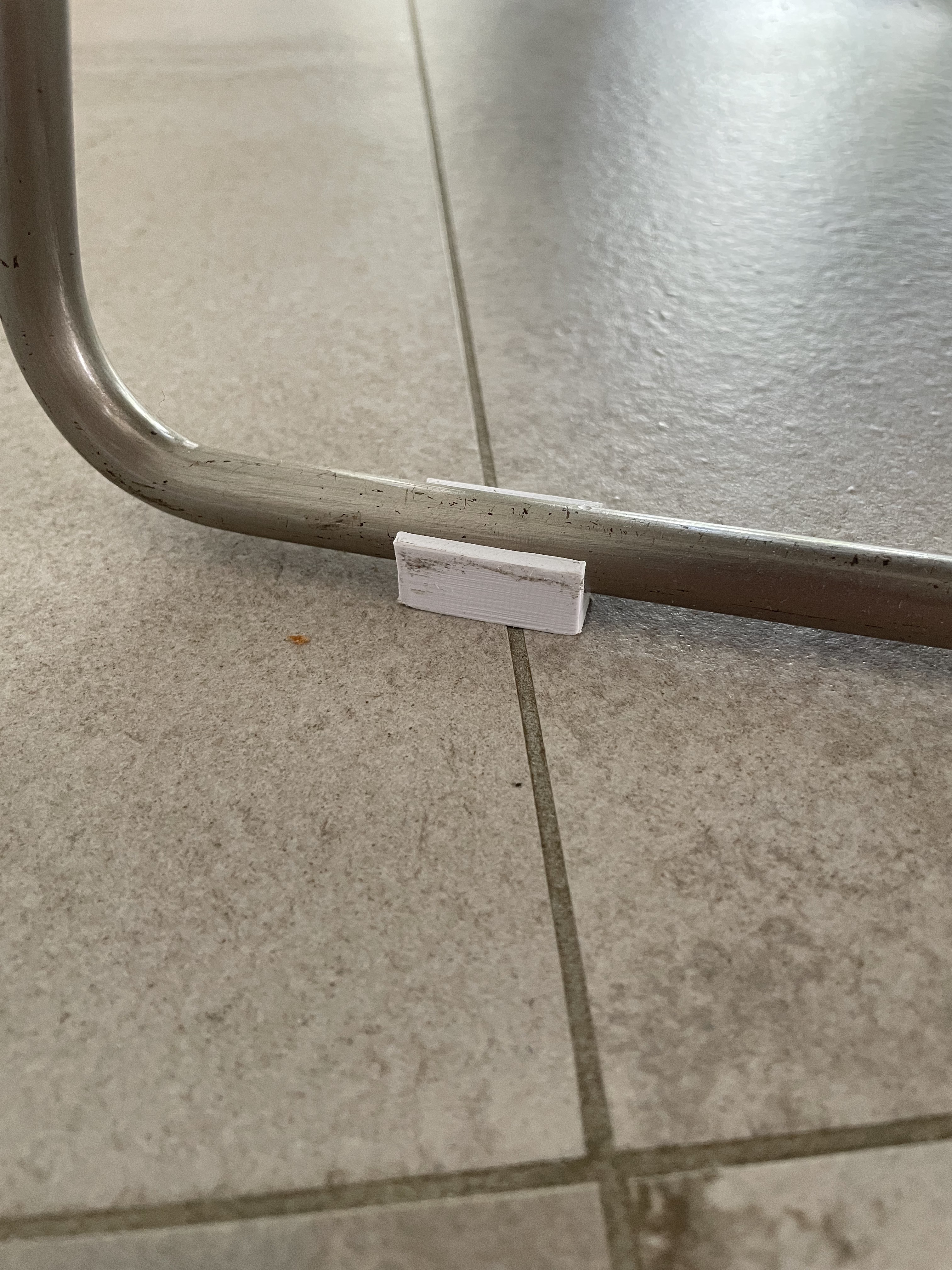 Chair skid clip on round metal bar