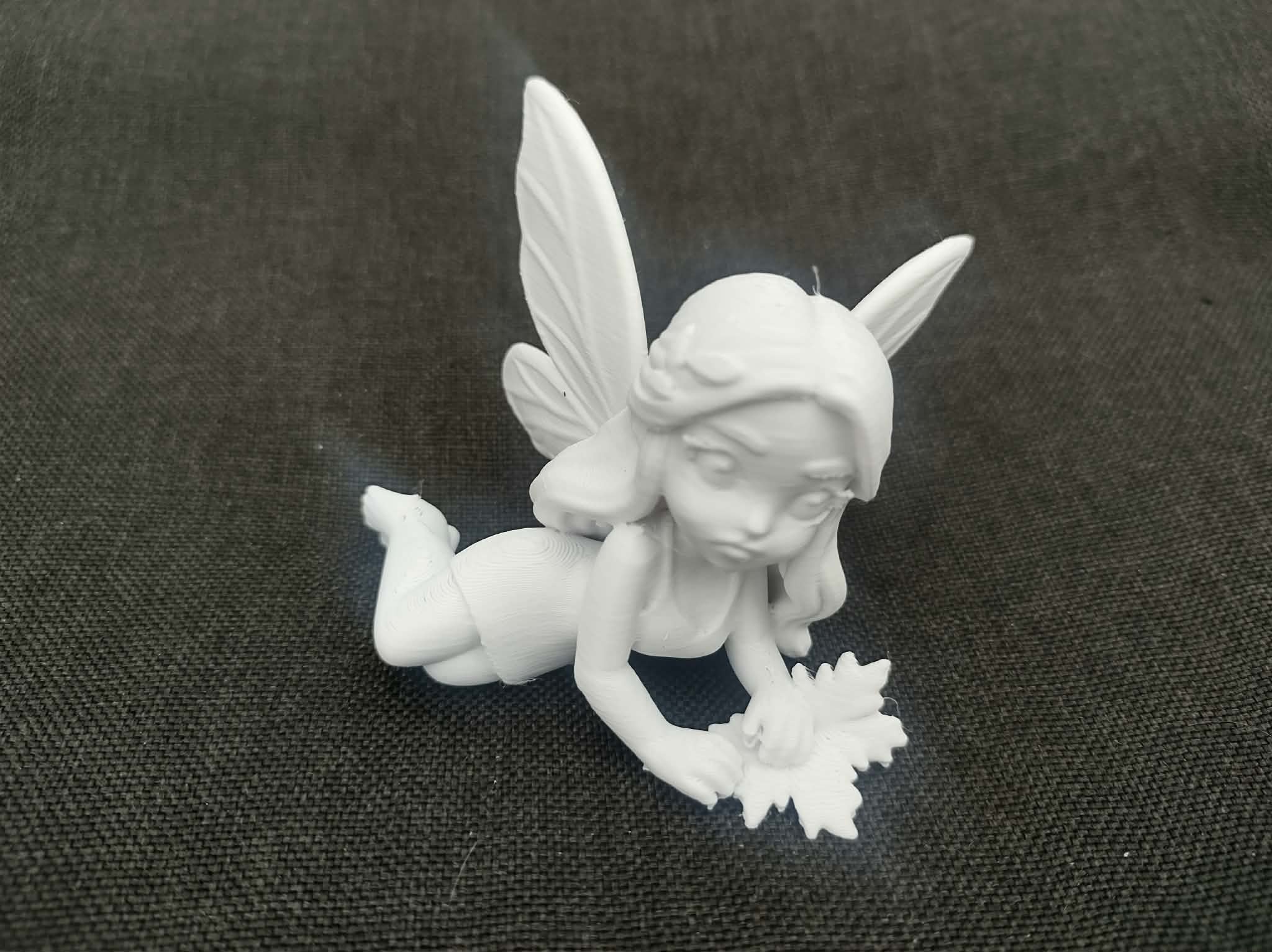 Woodland Fairy Laying on Side Holding Forest Leaves Statue
