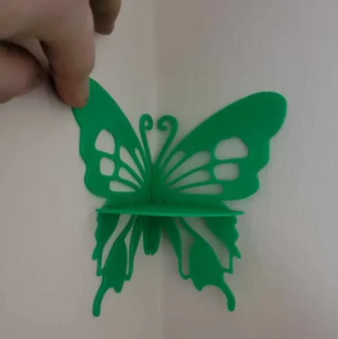 Butterfly on the wall with a shelf