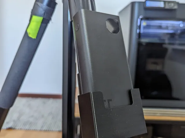 Powerbank holder for tripod leg