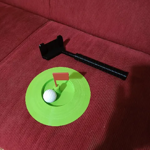 Golf putter practice hole and ball