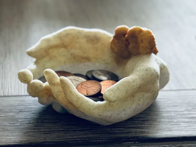 Cupped hands with birds on wrist holder