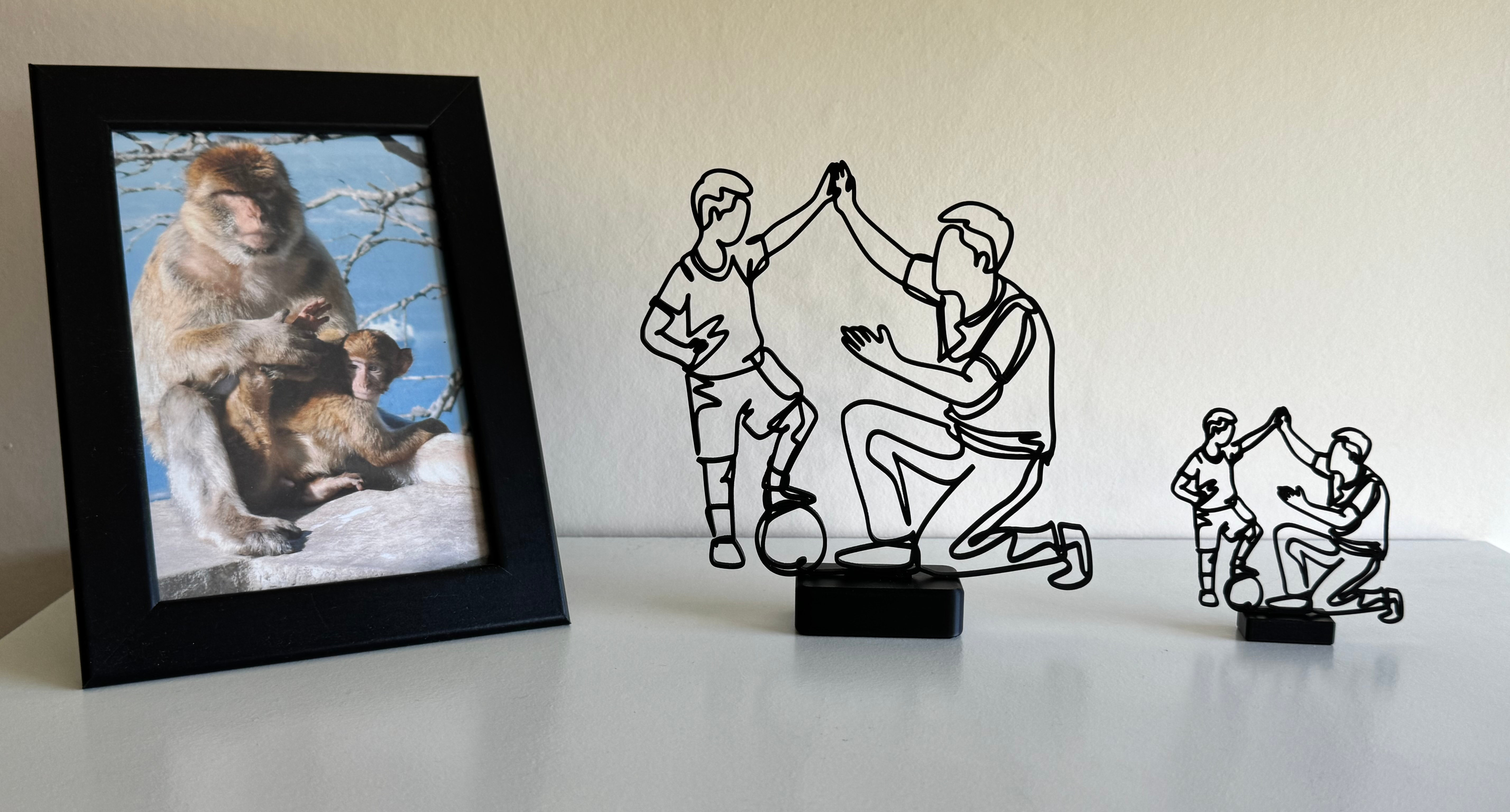 Man and Child Football Line Art Sculpture