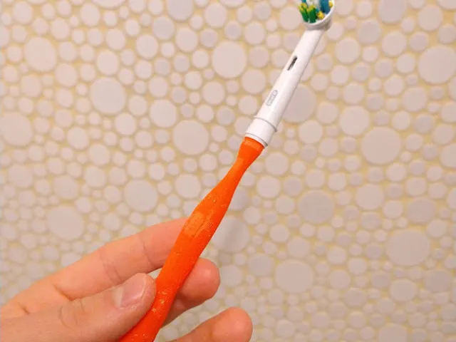Manual electric toothbrush bit holder