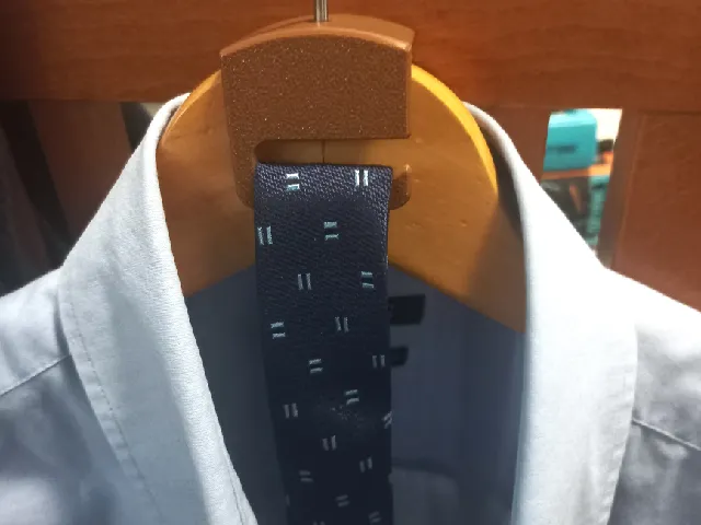 Tie peg for coat hanger