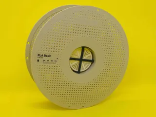 Mounting fixture for silica gel container inside Bambu Lab spool.