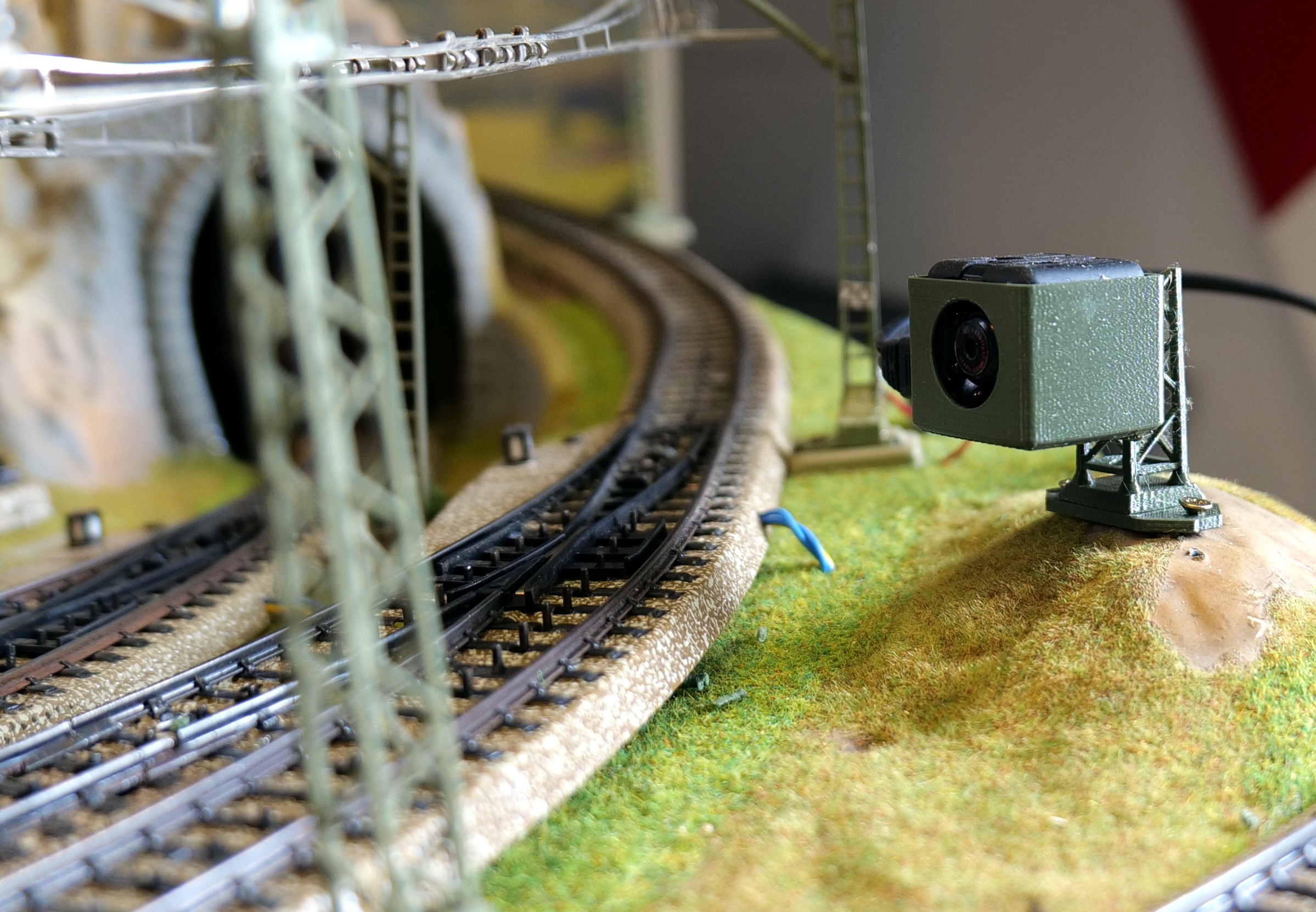 Mount for an SQ11 camera on a model railway. / Halterung für eine SQ11-Kamera auf einer Modelleisenbahn