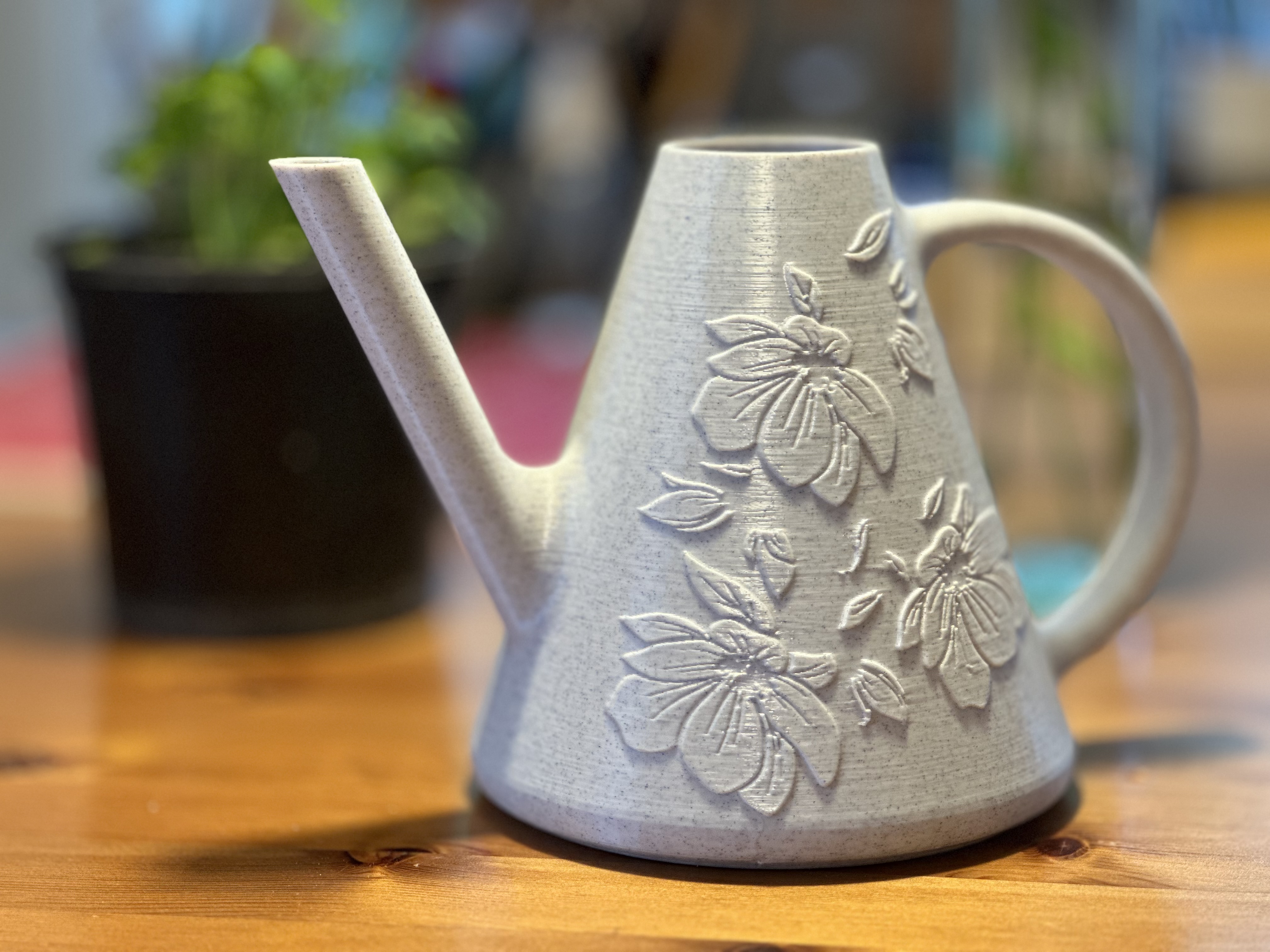 Decorative watering can with embossed floral designs