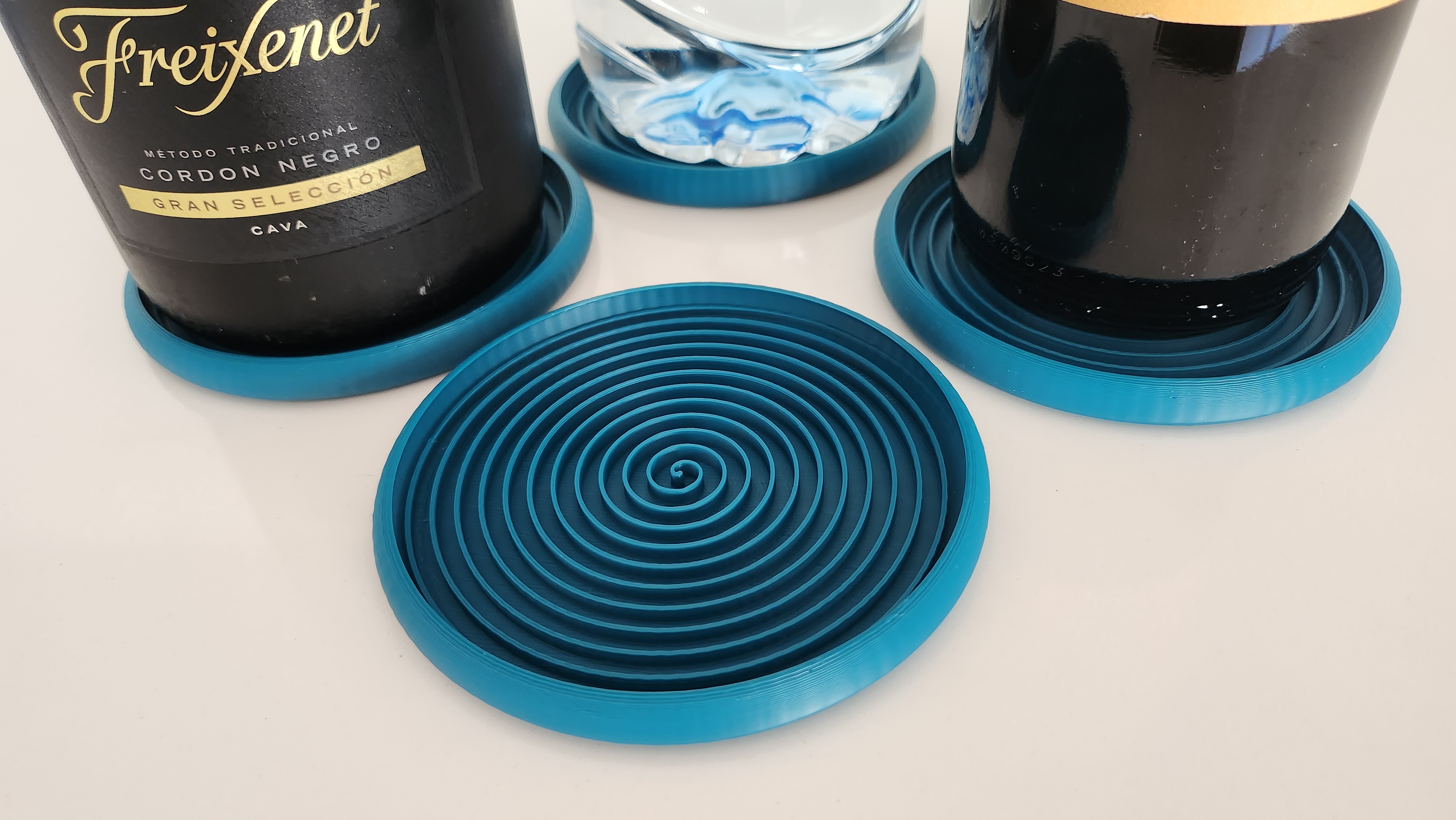 Stackable spiral coasters for larger wine bottles