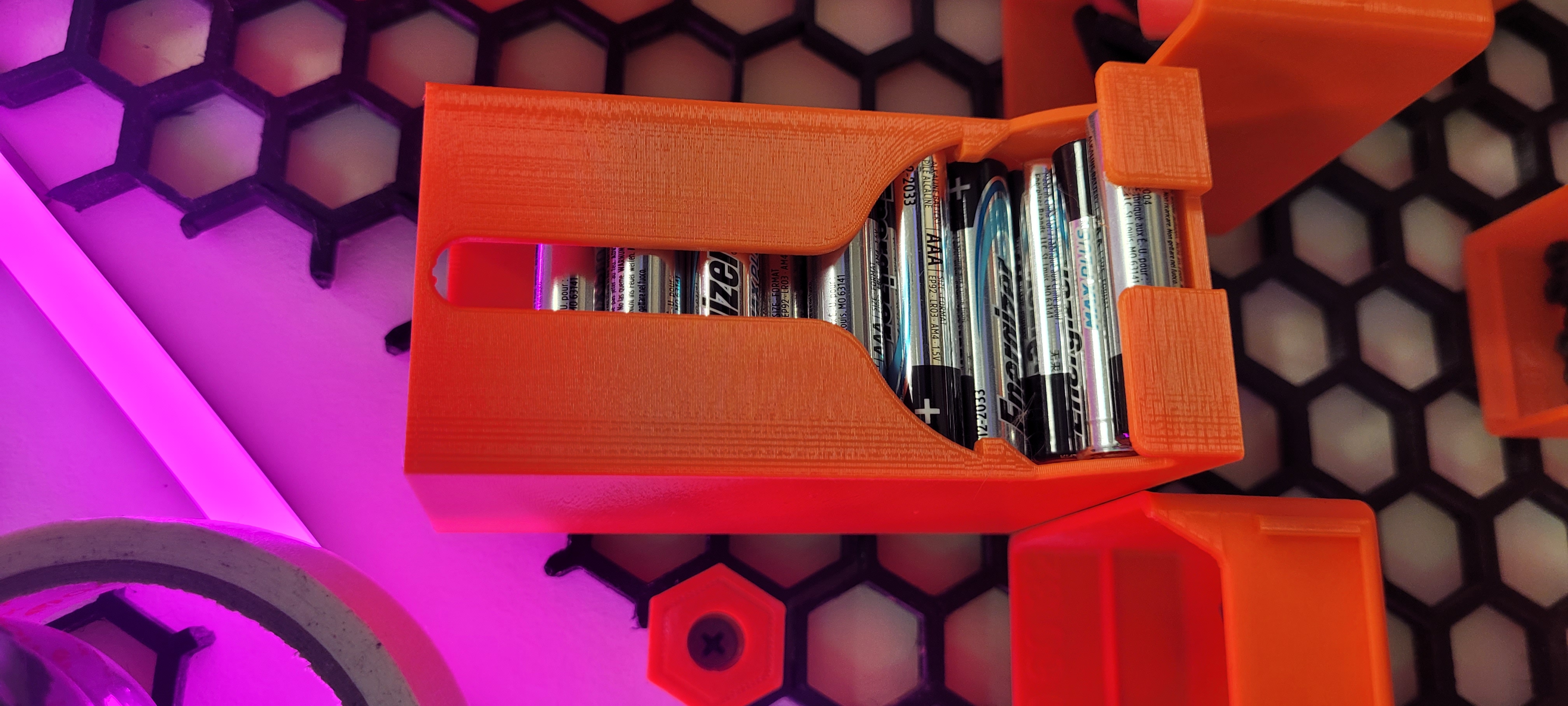 AAA battery dispenser for honeycomb wall