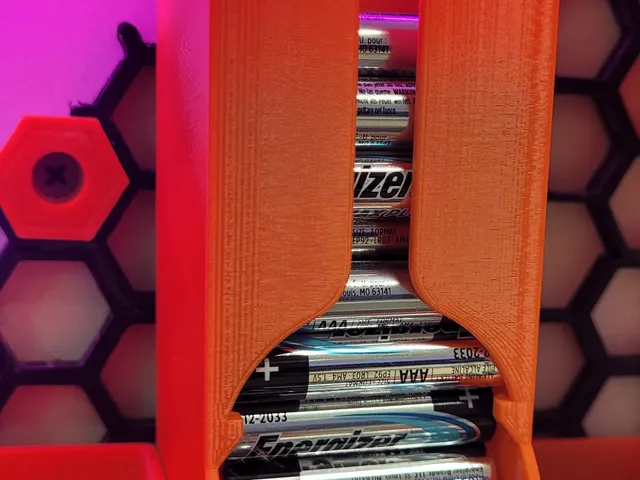 AAA battery dispenser for honeycomb wall