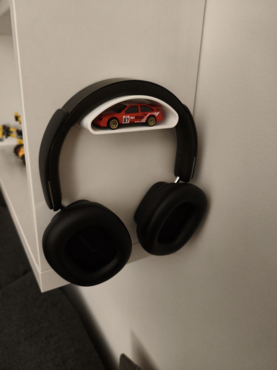 Headphone holder with extra storage compartment