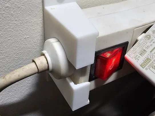 Power strip holder for power strip with ferrite bead