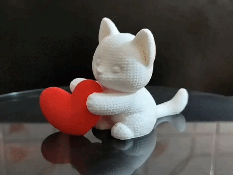 Kitten hugging heart