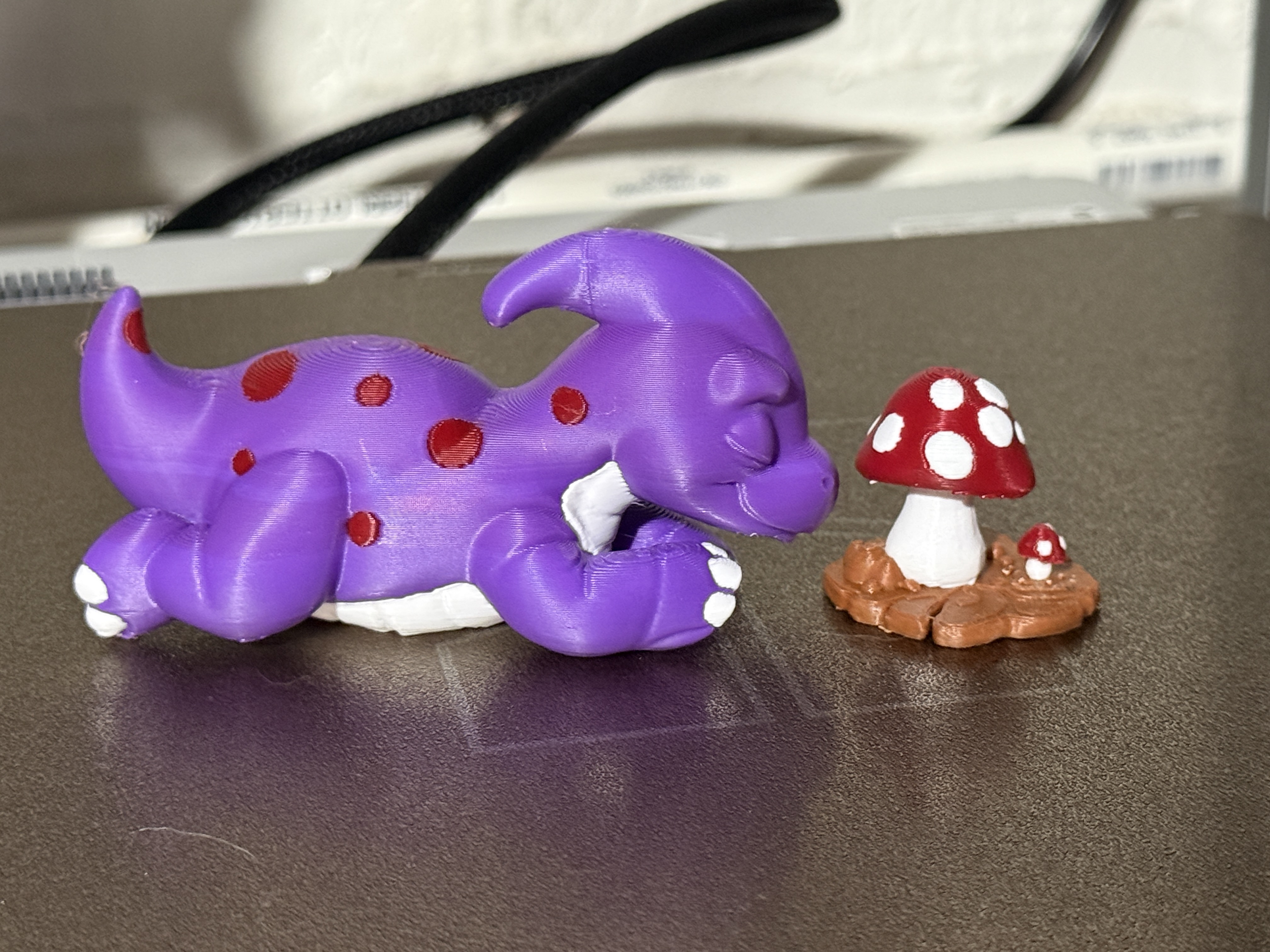 cute dino sleeping next to mushrooms