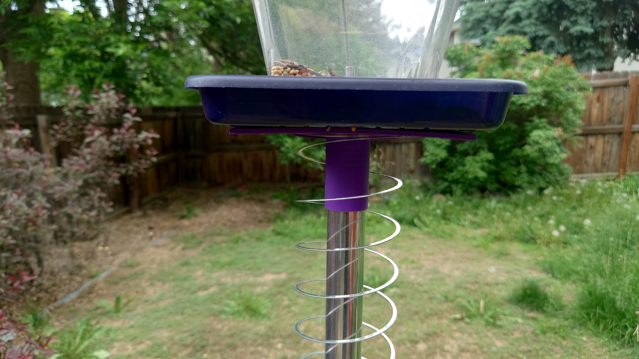 Bird feeder pole bracket with squirrel baffle