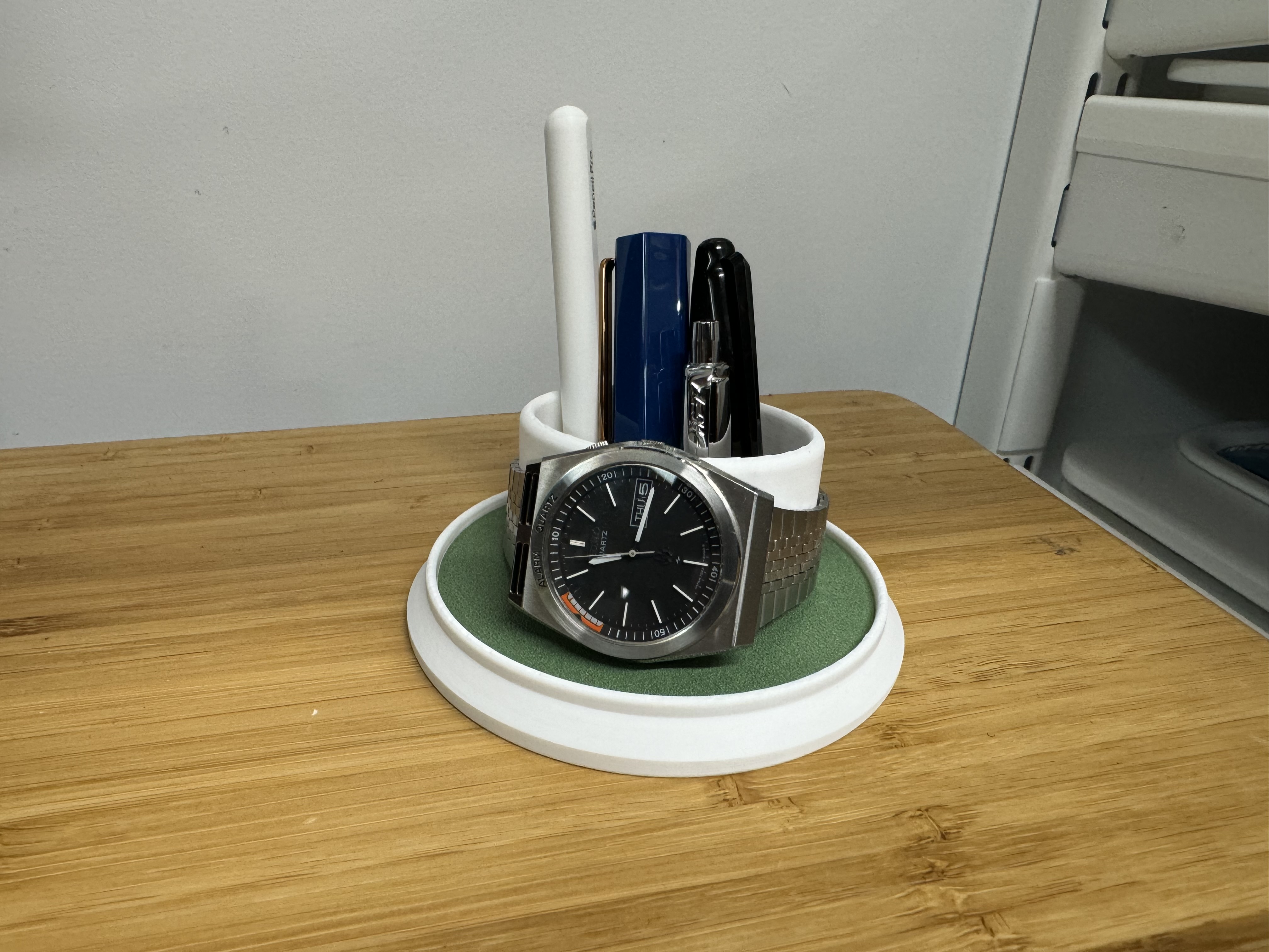 Desk-hole watch tray with secret pen cup