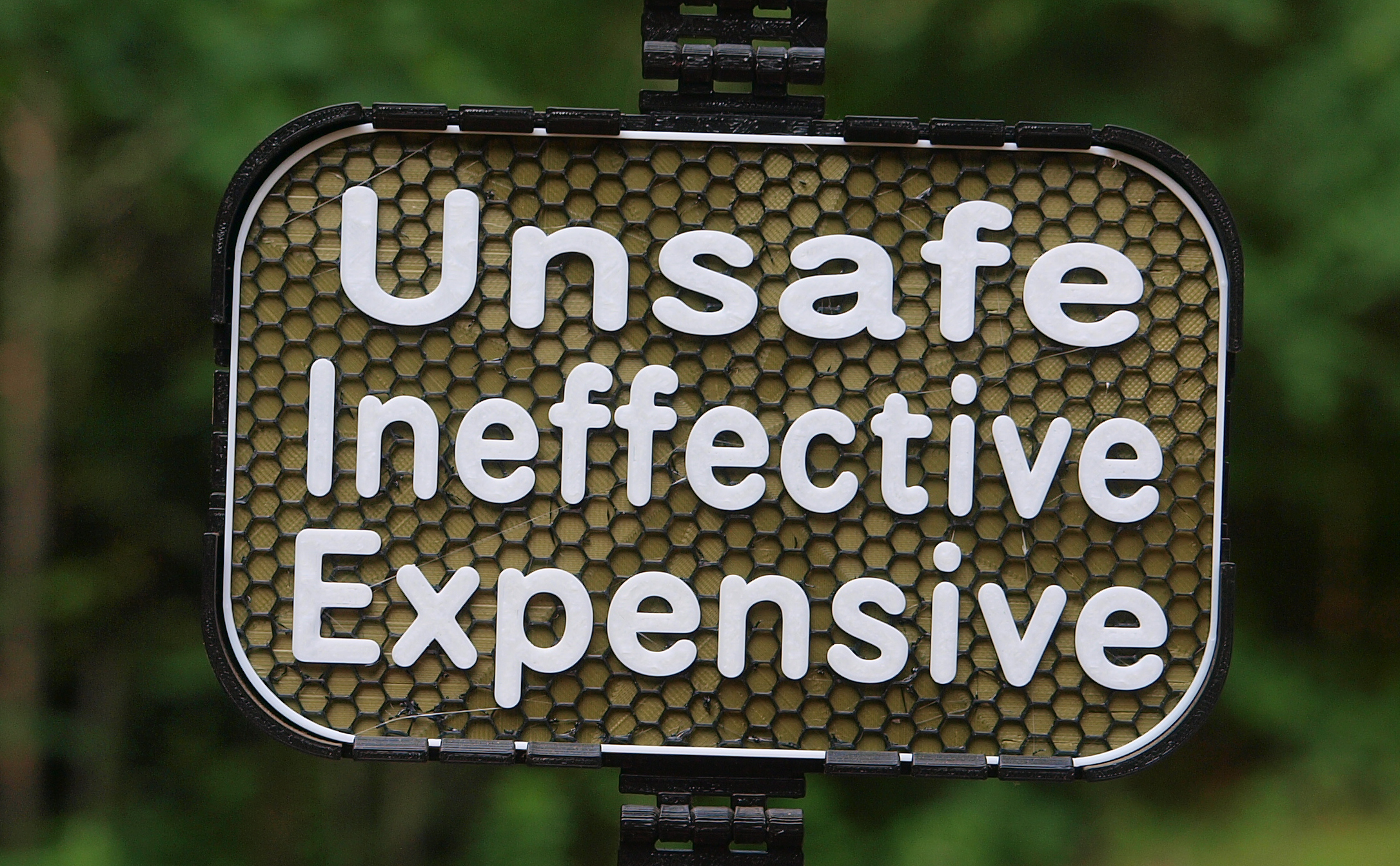 "Unsafe, Ineffective, Expensive" sign