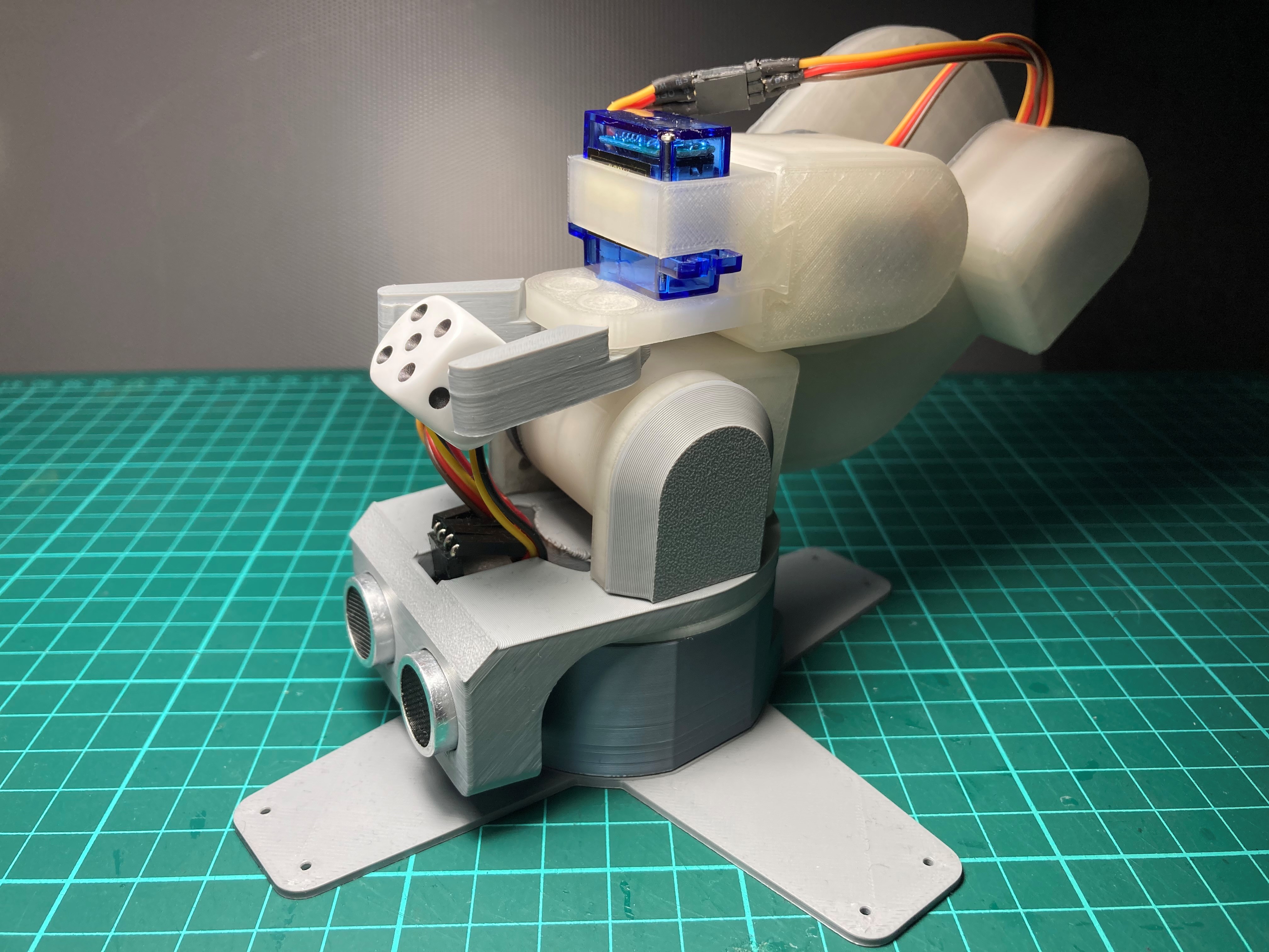 A mini robotic arm with an ultrasonic sensor for beginners