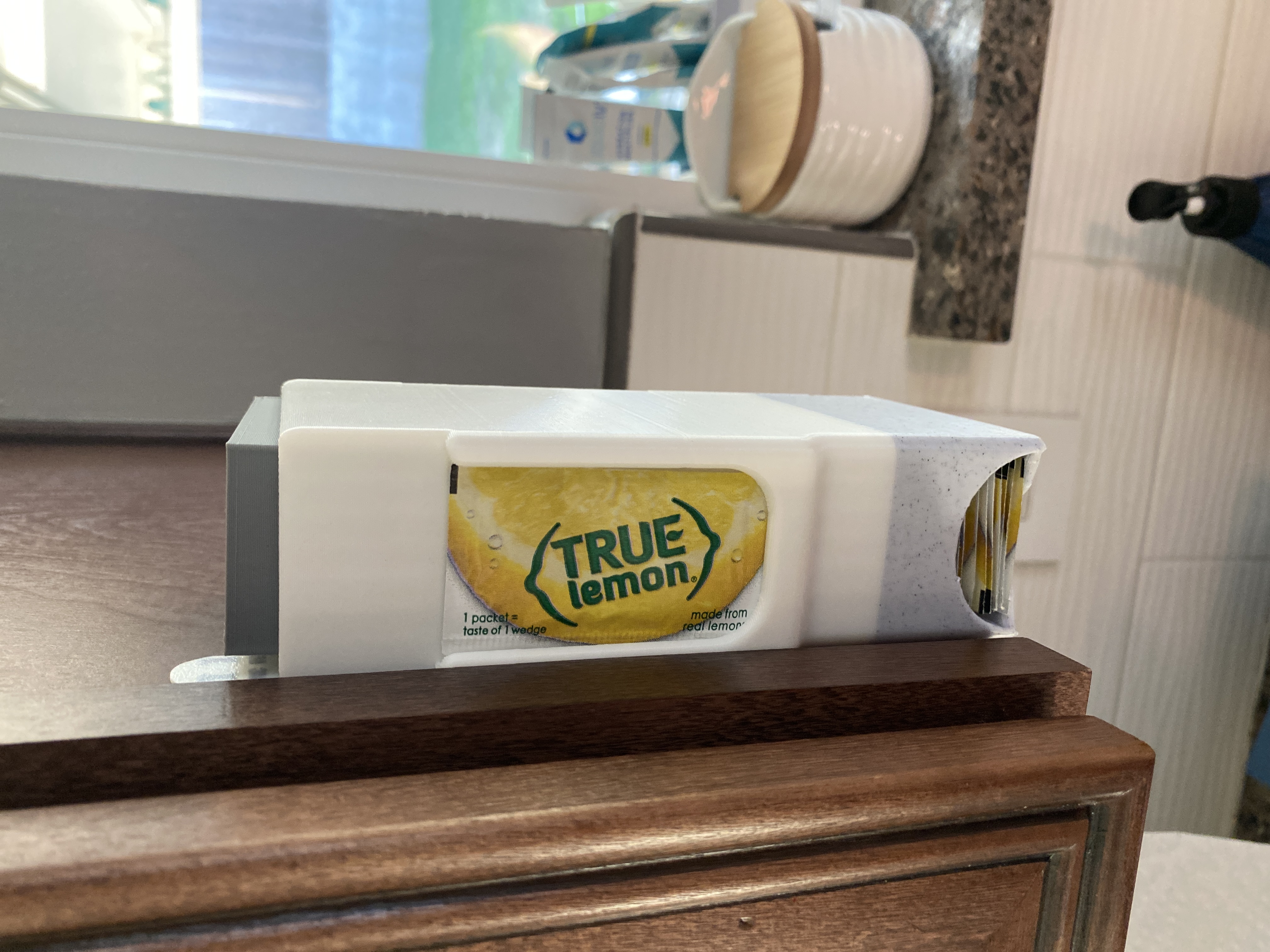 Taller True Lemon packet dispenser with weight block