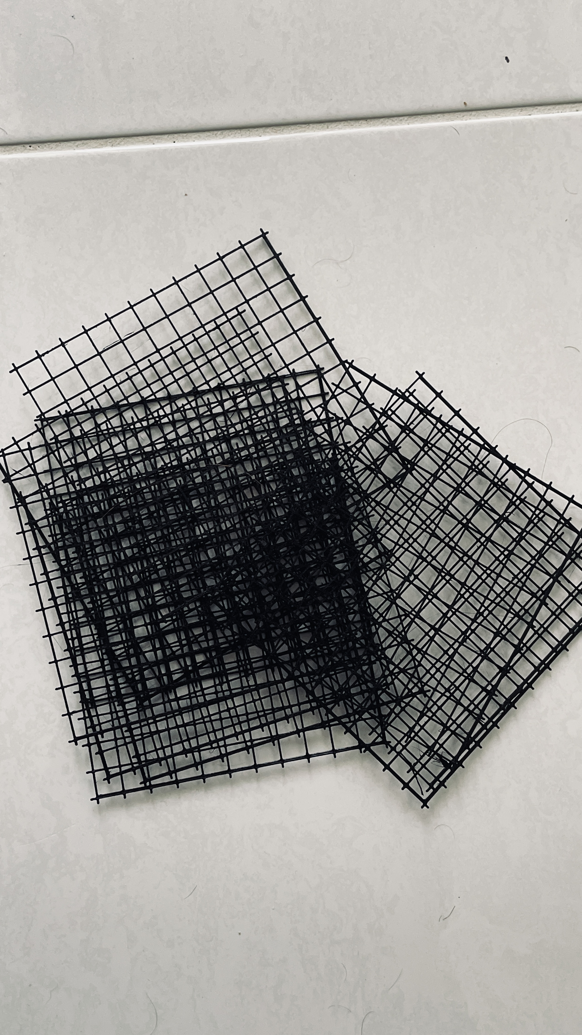 Throwaway shower grate to catch hair