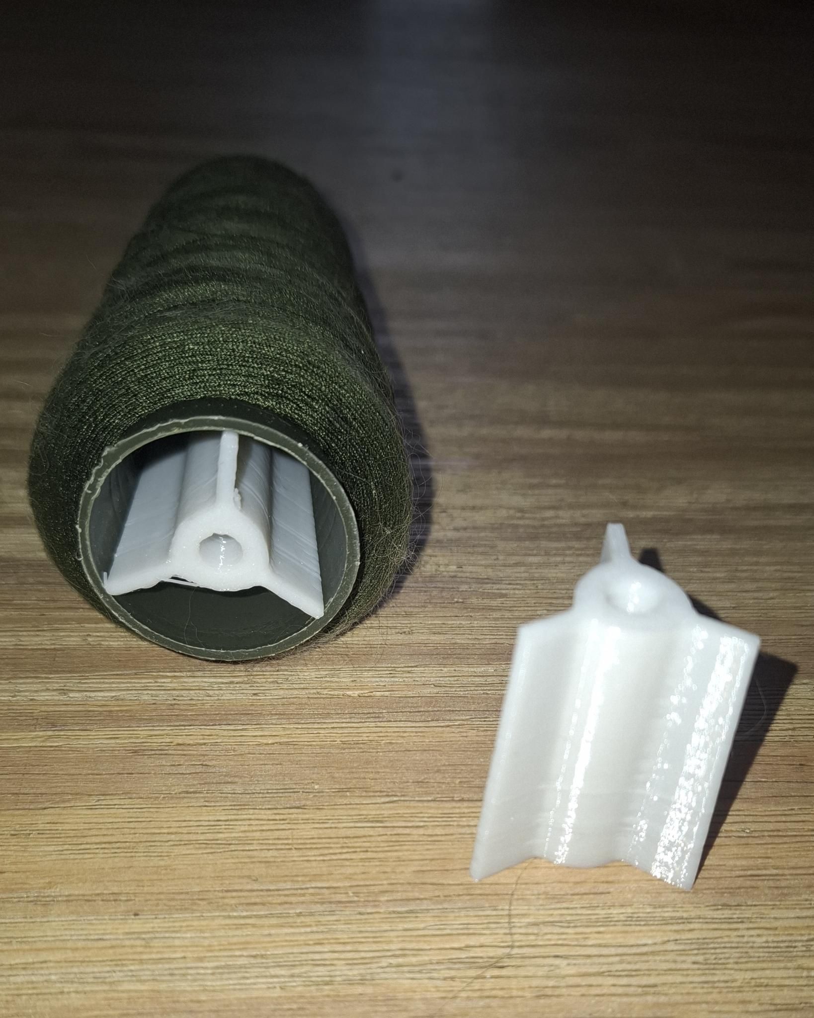 Adapter for using overlock thread spools on a household sewing machine
