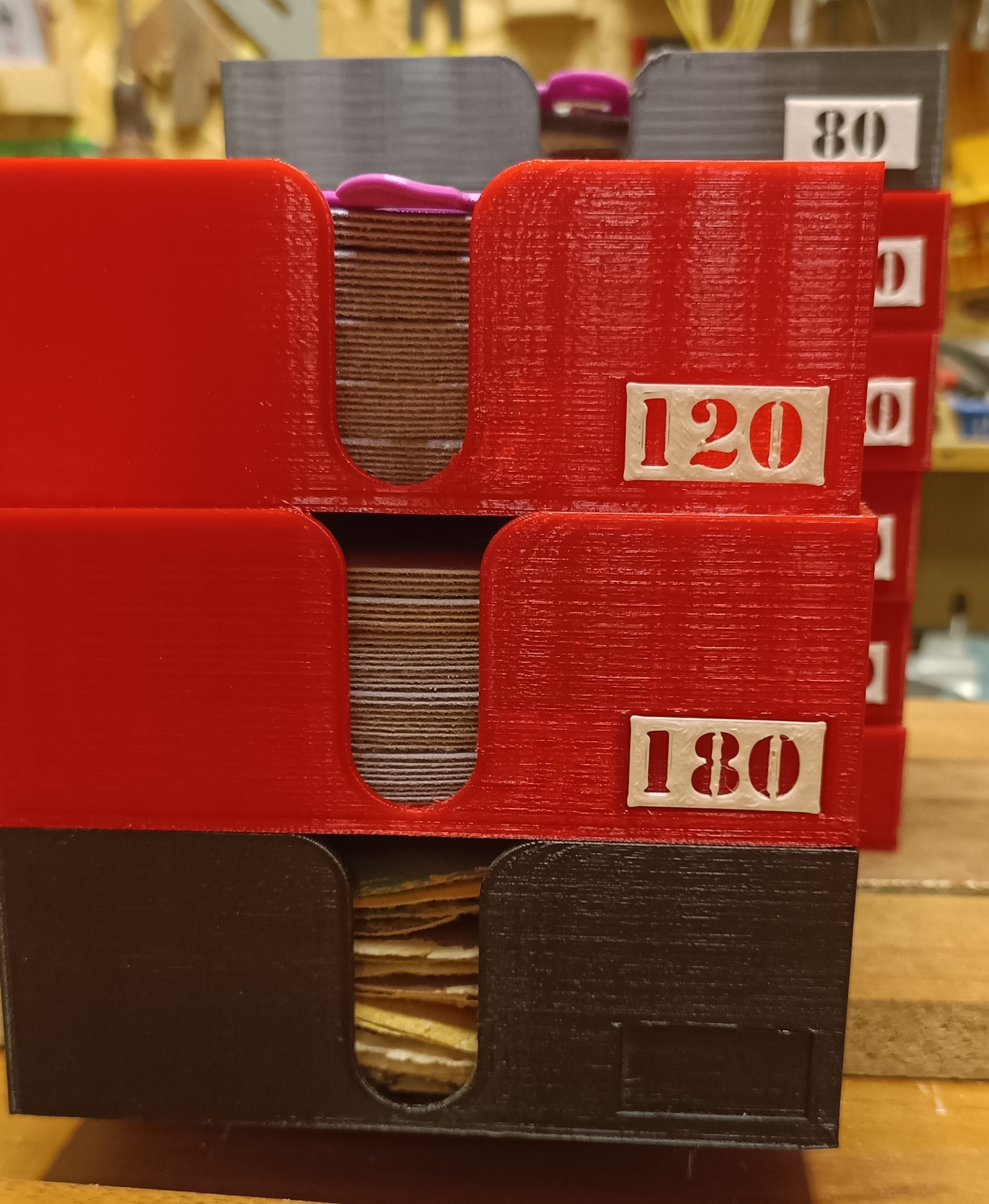 Set of trays of various depths for grinding discs, dividers, and grit labels.