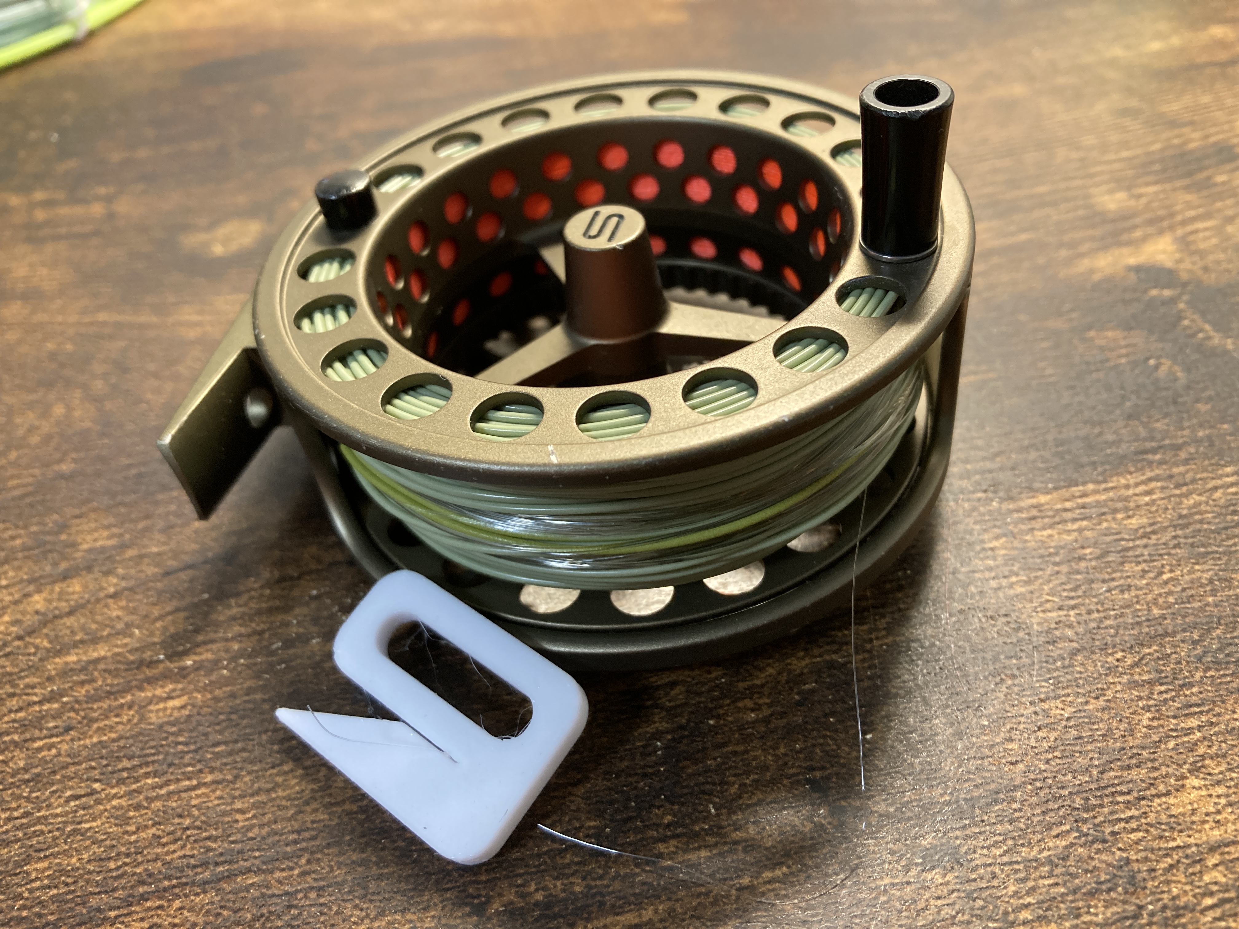 Fishing line stopper for fly reel