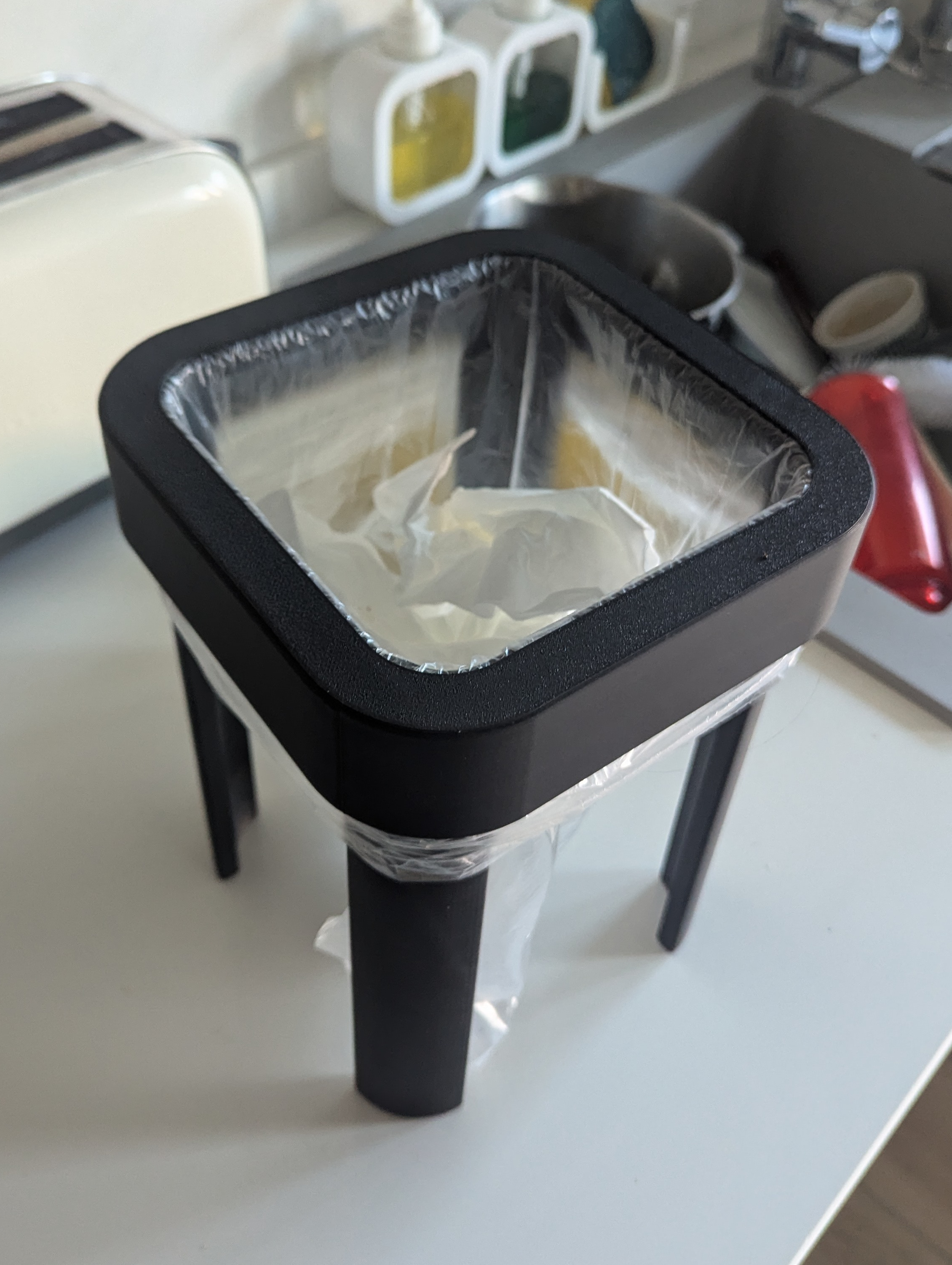 Trash bag holder for surfaces