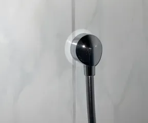 Intermediate piece for securing a cover cap of a shower hose connection