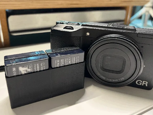 A compact case for Ricoh GR II securely holds 4 DB-65 batteries