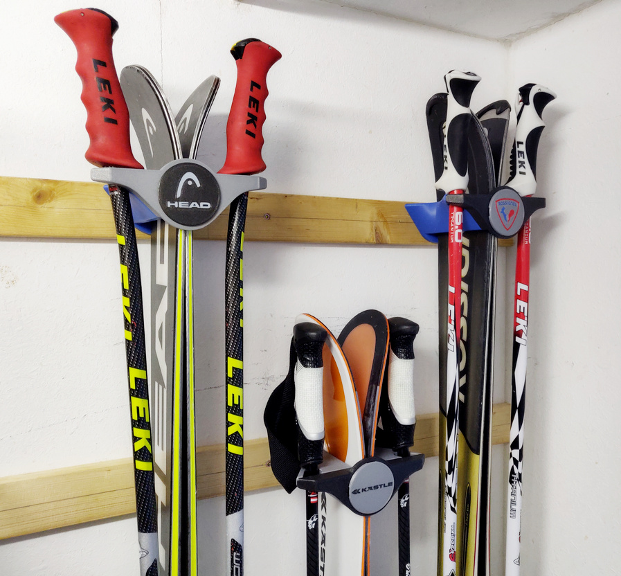 Designer wall mount for storing and displaying skis and ski poles with logo/nameplate