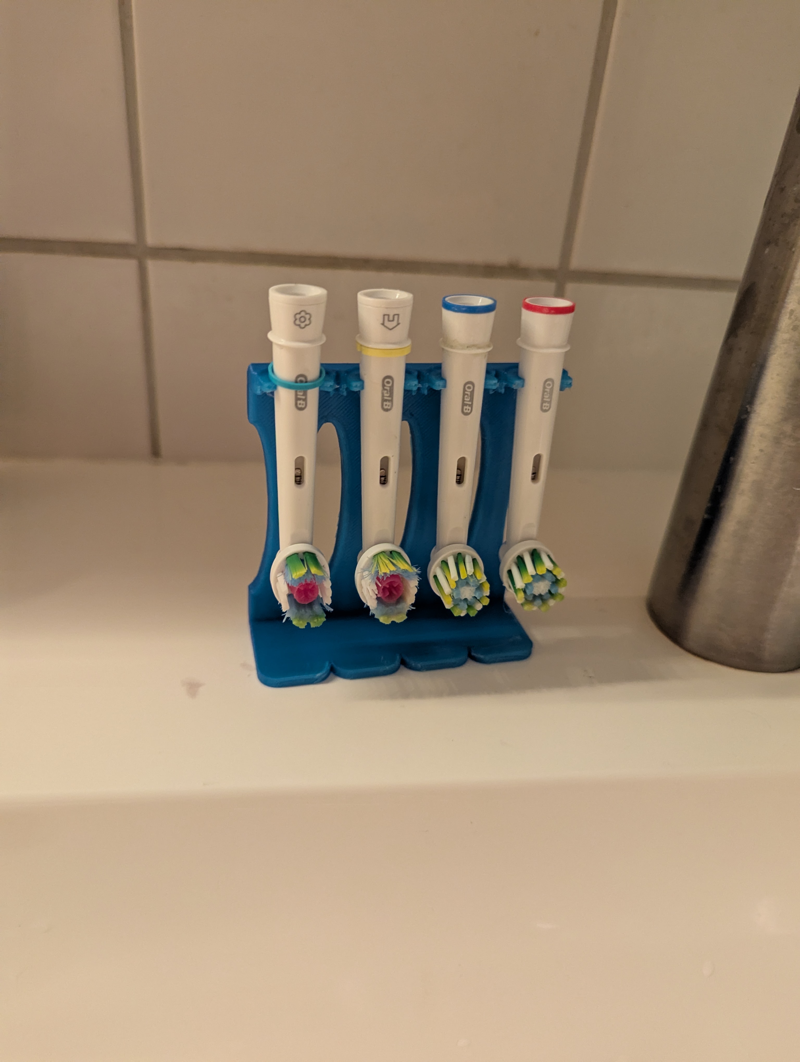 Oral-B electric toothbrush head stand.