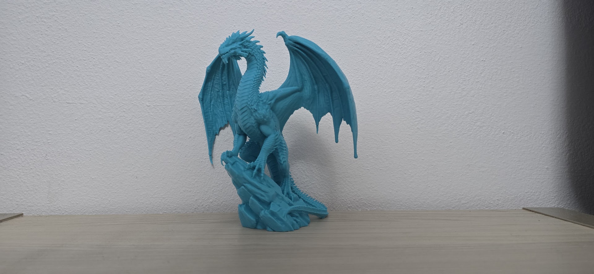 Turquoise Ancient Dragon on Rock Statue
