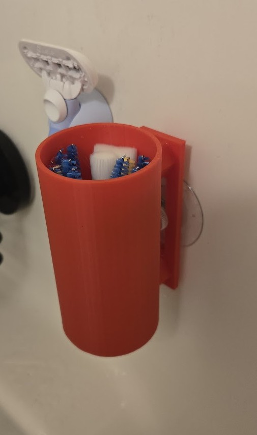 Shower item holder cup held by suction cup