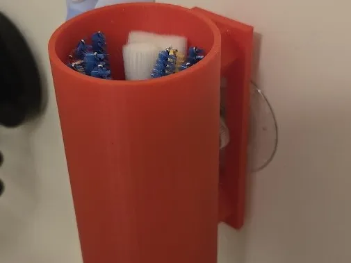 Shower item holder cup held by suction cup