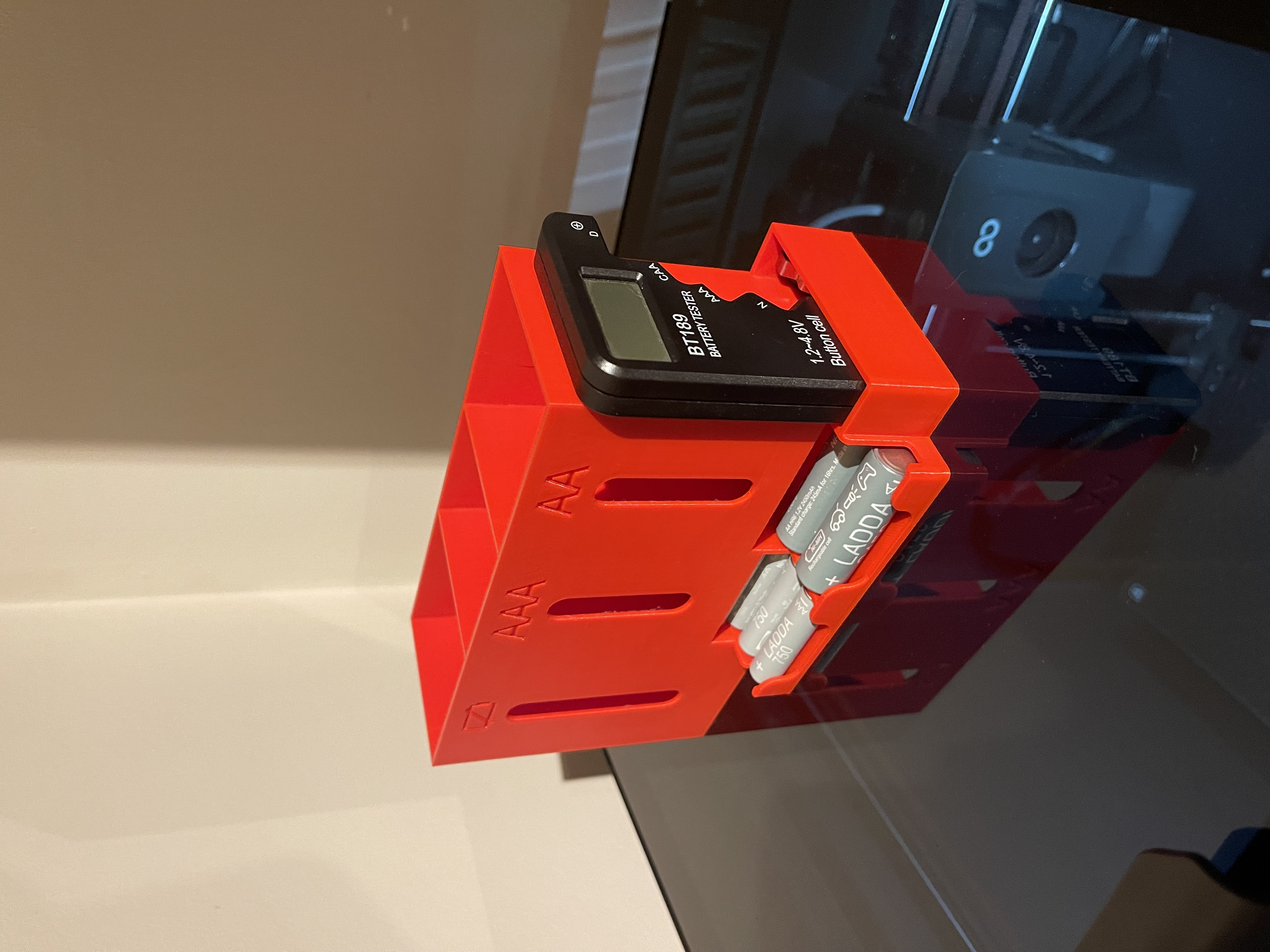 Battery dispenser (AA/AAA) with empty bin and tester storage