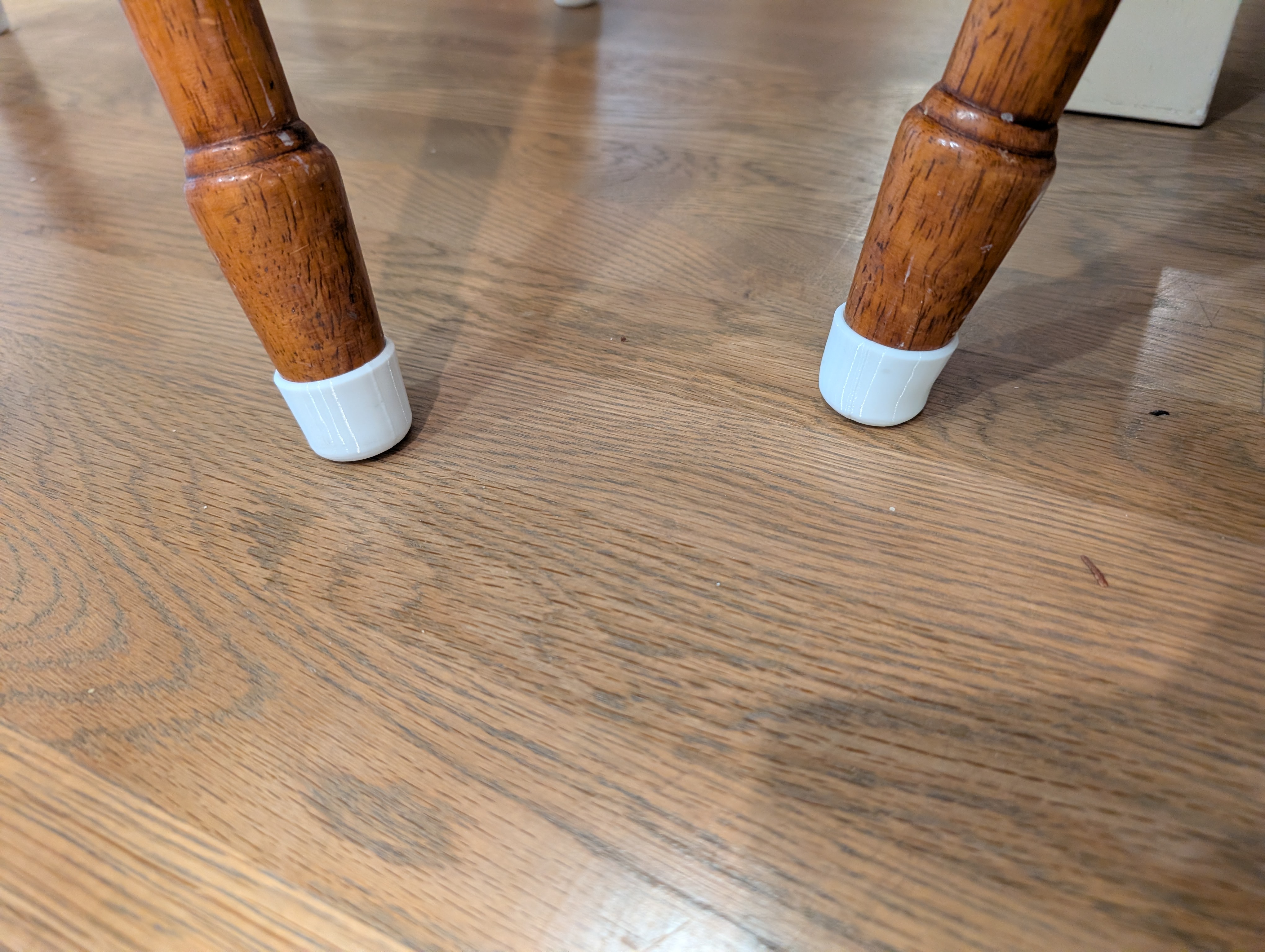 Feet / covers for dining room chair legs.