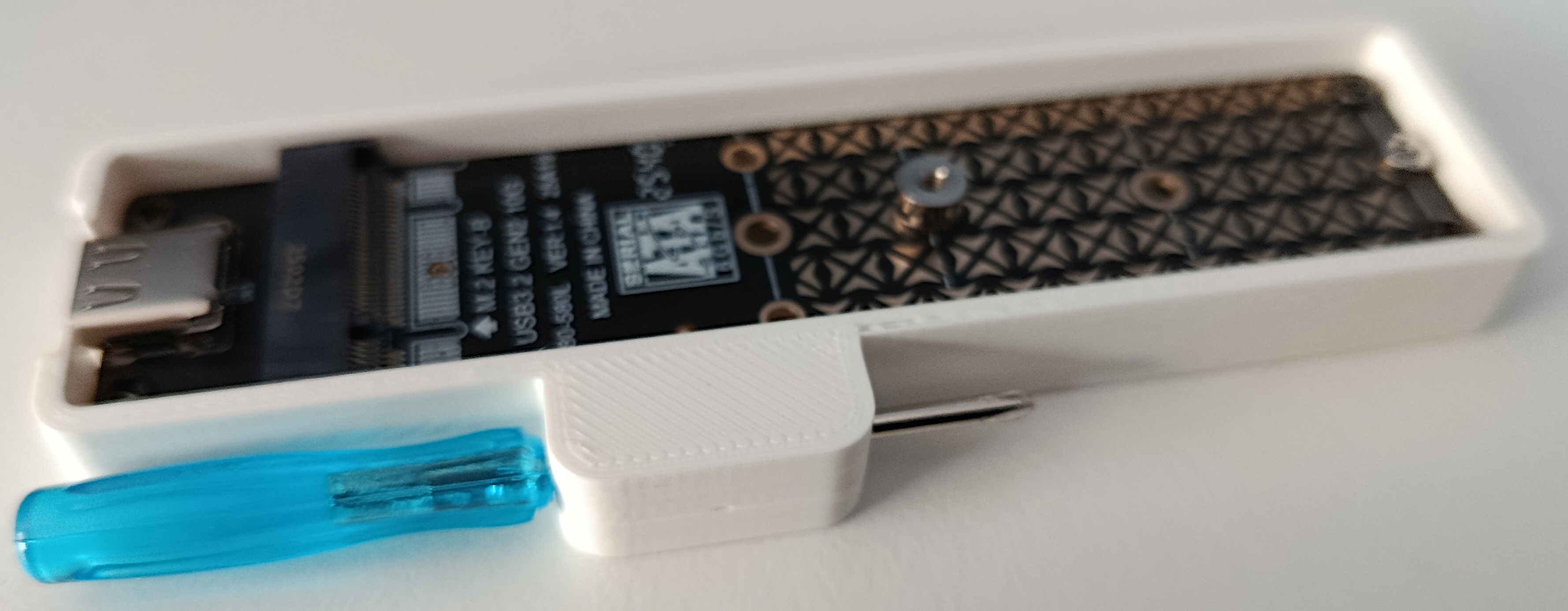 Holder for AliExpress USB to M.2 adaptor with screwdriver storage