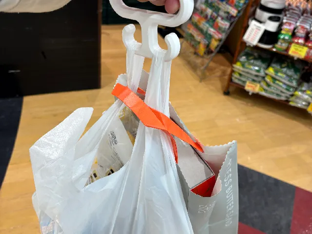 A hook that makes carrying plastic bags more comfortable.
