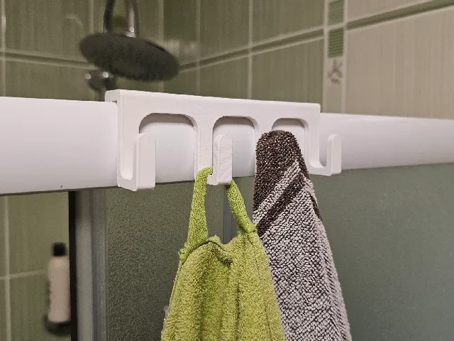 Hanging towel rack for the shower wall