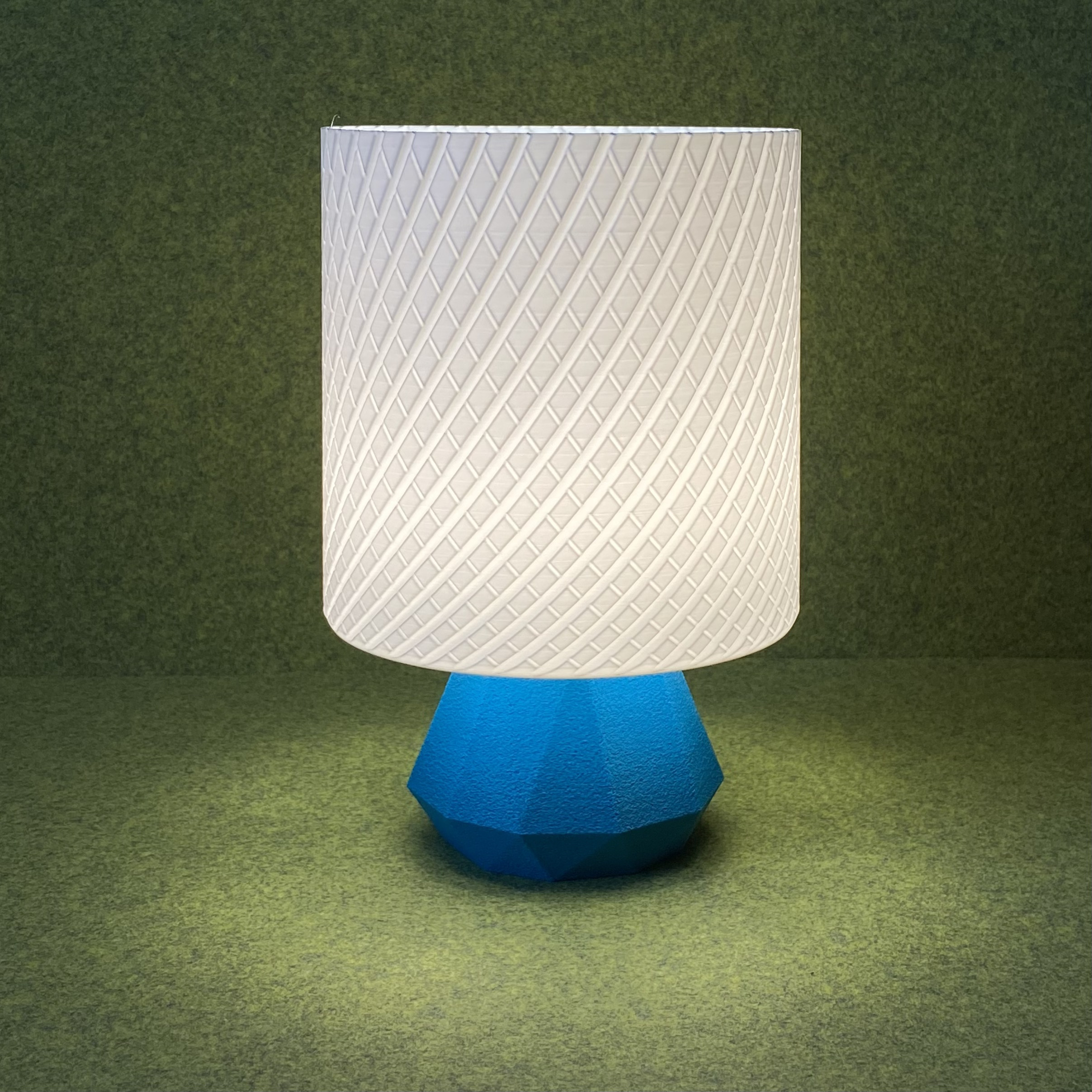 Small table lamp with lattice shade and low poly base