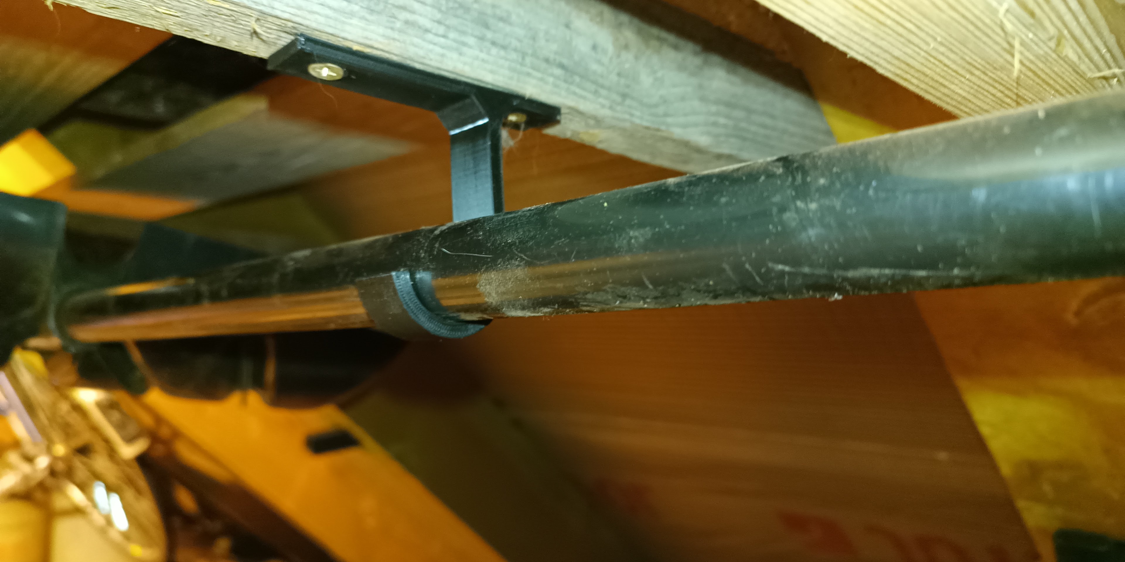 Ceiling mounted brrom or snow shovel hook/holder