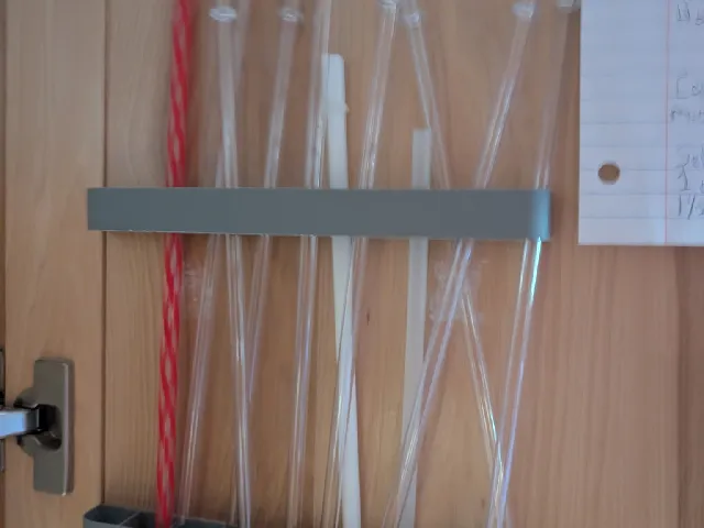 Straw holder for cabinet