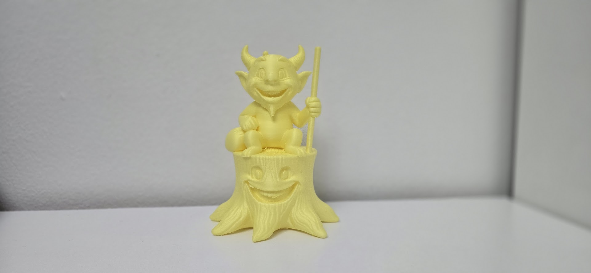Cheerful Devil on a Tree Stump Figurine
