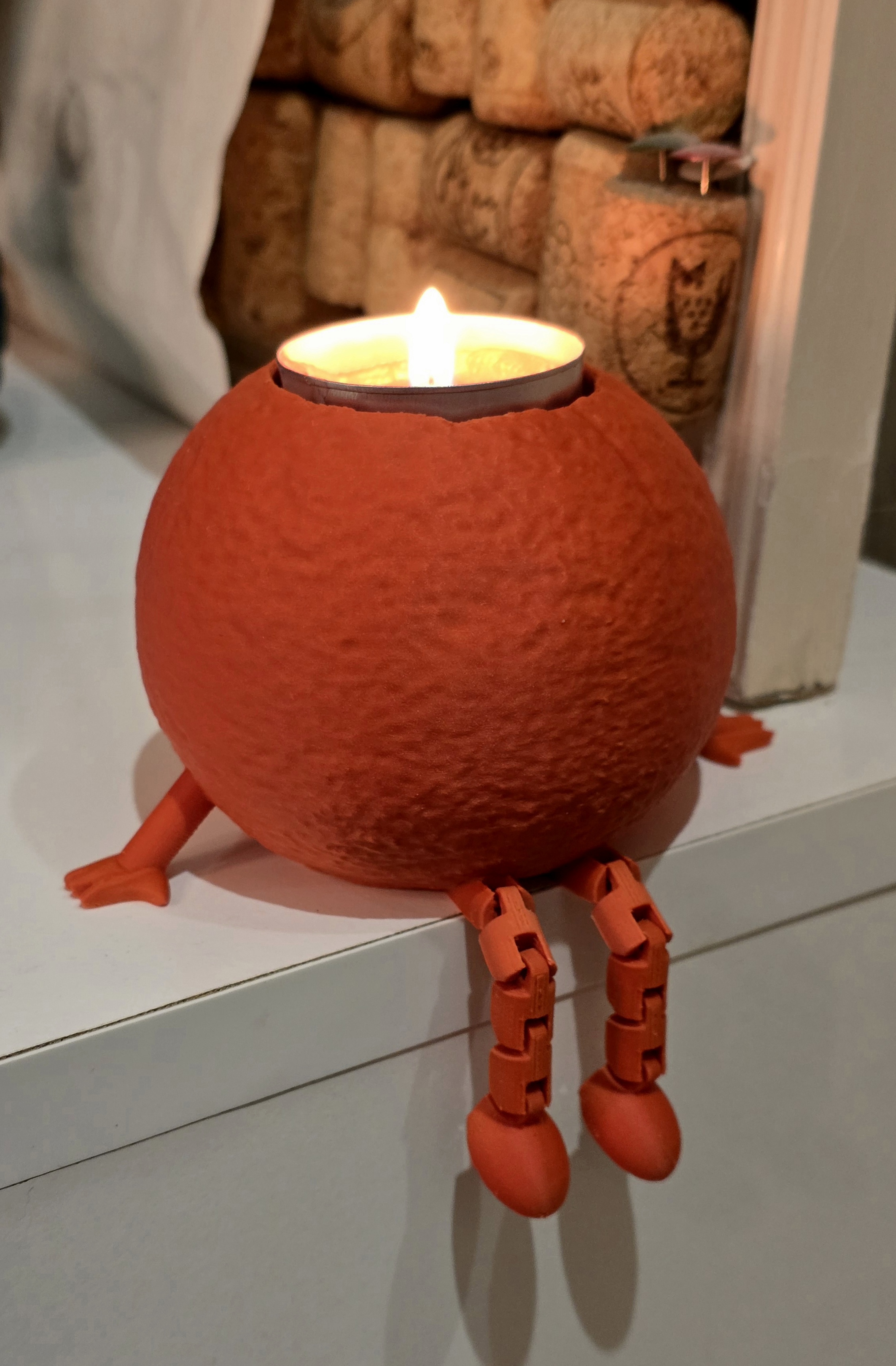 Articulated orange tea light candle holder