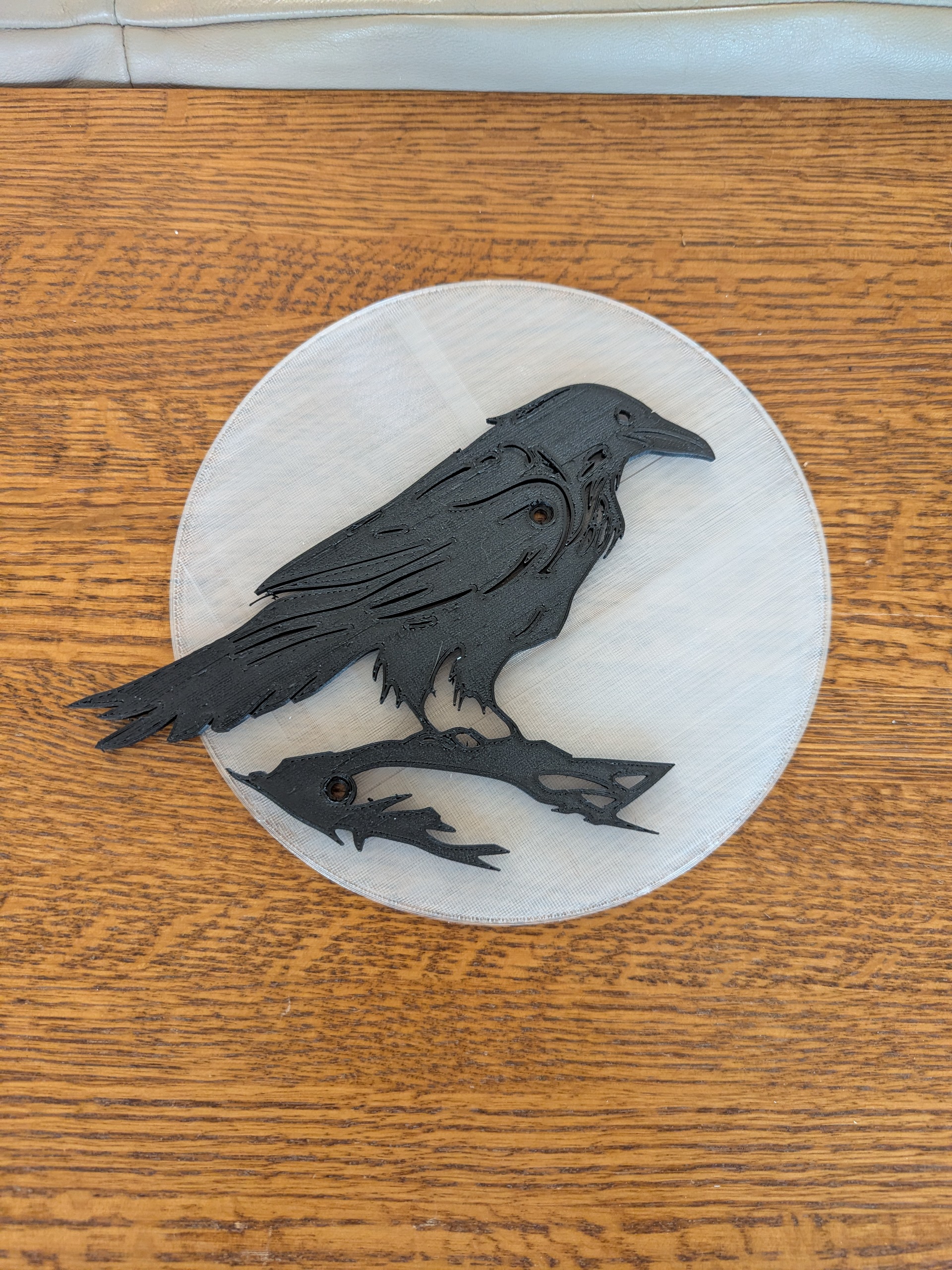 Crow outline in front of moon, more simple